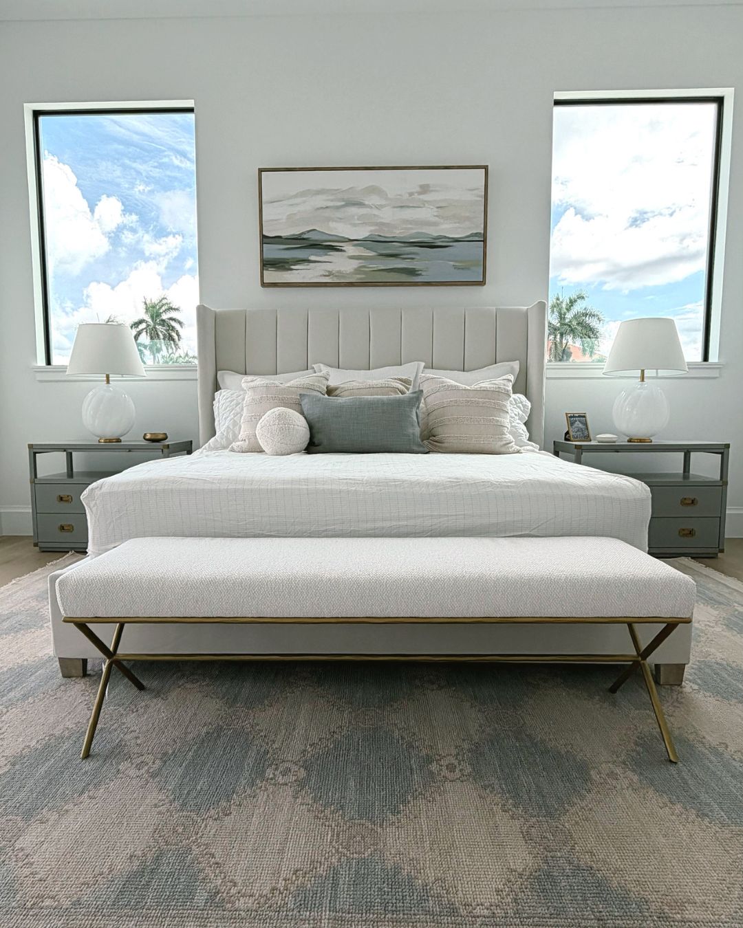 Grounding fitted sheet on a bed in a bright bedroom